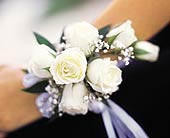 7 White Mini Roses Wristlet in McDonough GA, Absolutely Flowers